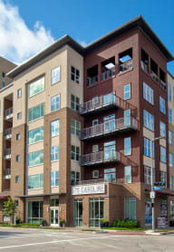 a swimming pool with an apartment building in the background