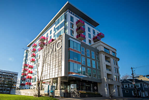 A modern building with a glass facade and a sign that reads "THE".