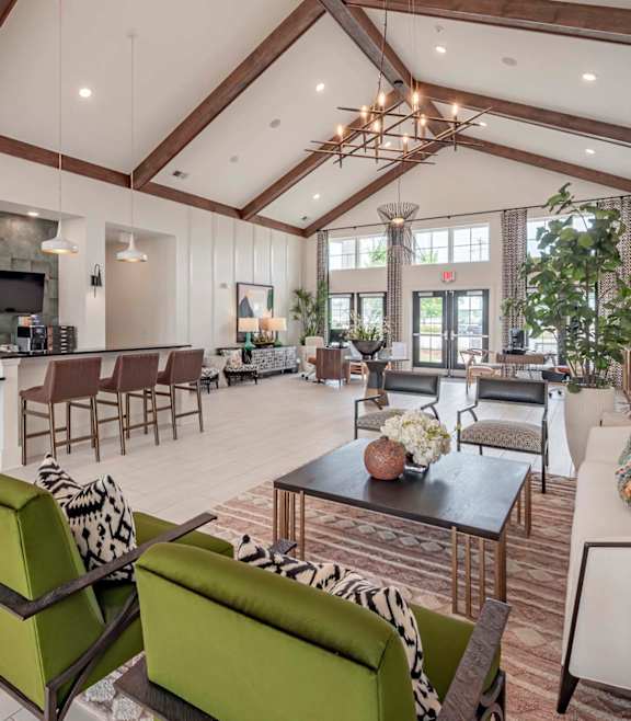 A modern living room with a stone fireplace and a large open space at Waterleaf at Neely Ferry Apartments, Simpsonville, SC