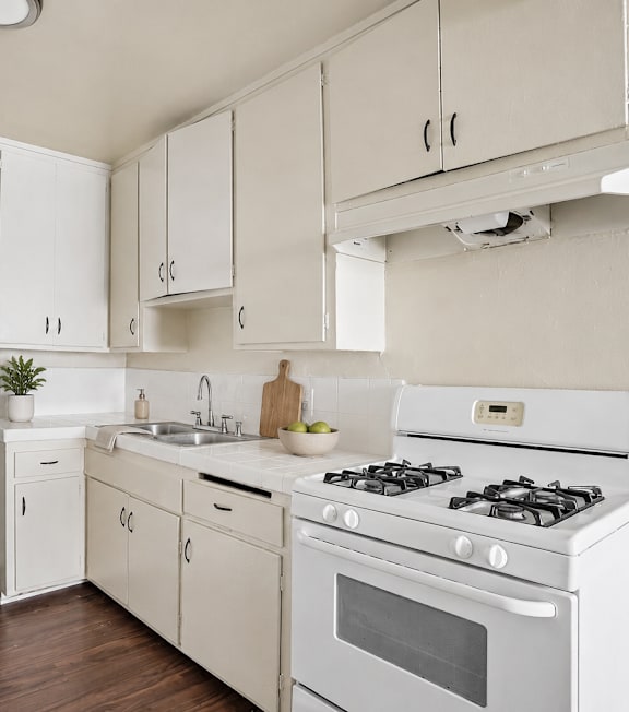 A well-lit, modern kitchen and living room with a dining area.