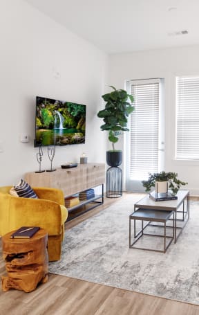 a living room with white walls and hardwood flooring