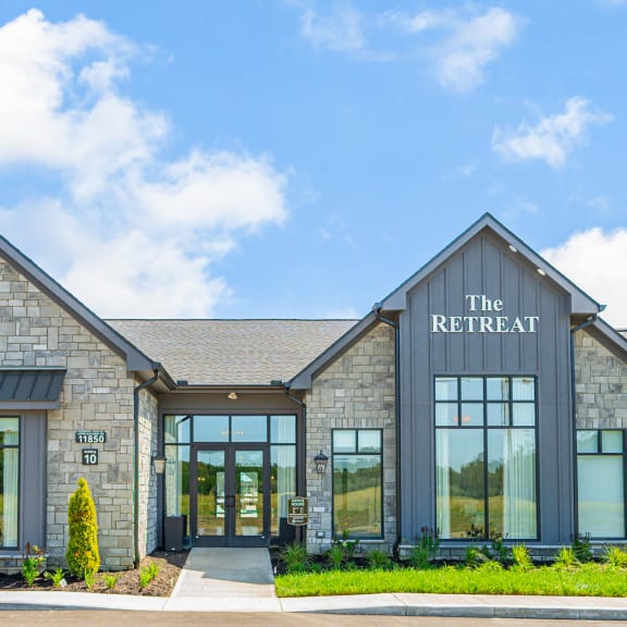 the retreat building with large windows and a blue sky