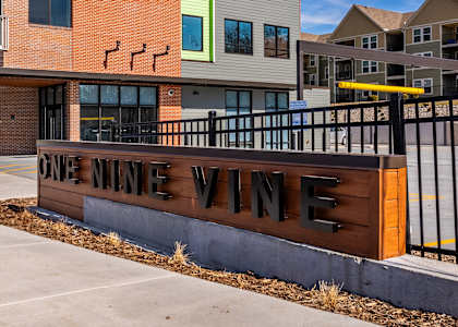 A sign that says One Nine Wine in front of a building.