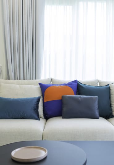 a sofa with colourful cushions at West Mall Place Apartment Homes, Everett, Washington