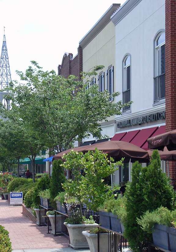 A woman is standing outside of a Sullivan's store.
