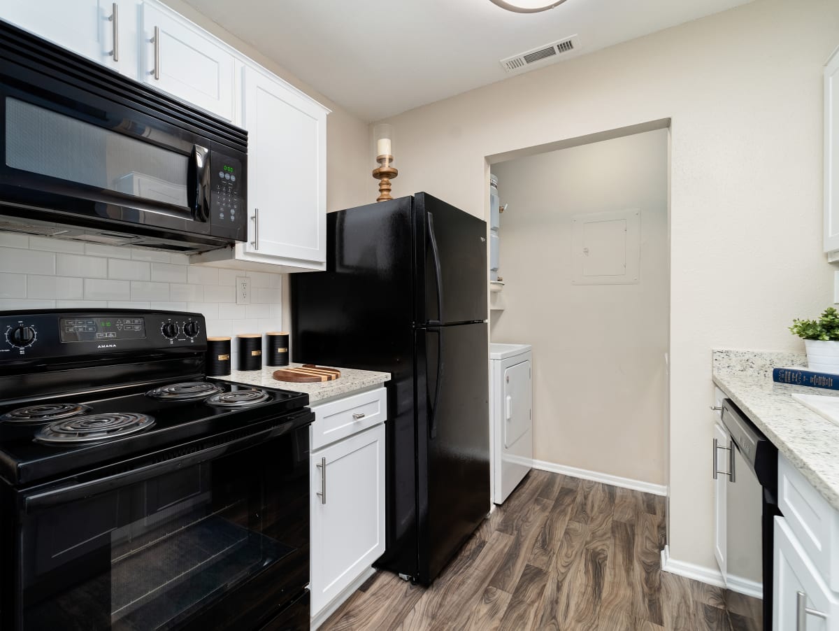 Rise at Signal Mountain Apartments kitchen with white cabinetry and black appliances - Chattanooga, TN