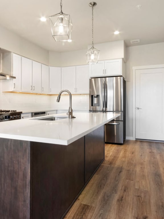 a kitchen with white cabinets and a white counter top