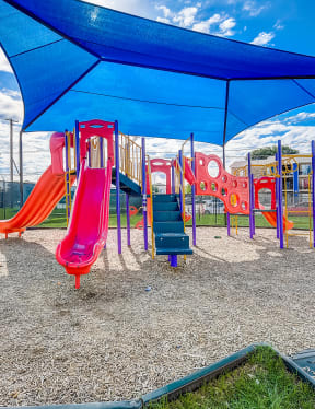 a playground with a swing set and slides