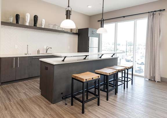 A modern kitchen with a large island and bar stools. at Crossroads 389 Apartments, New Jersey, 07601