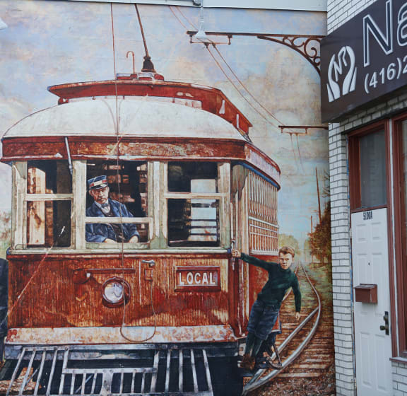 a mural of a streetcar on the side of a building
