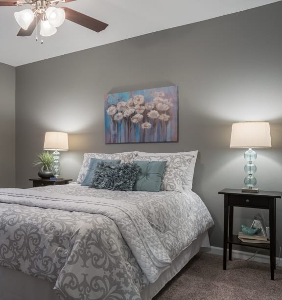 a bedroom with a bed and a ceiling fan