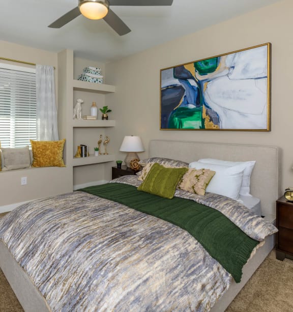 a bedroom with a bed and a ceiling fan