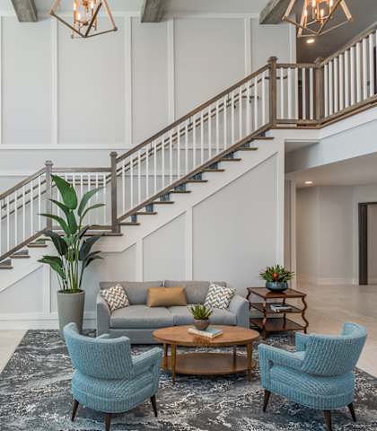 A living room with a staircase and a couch.