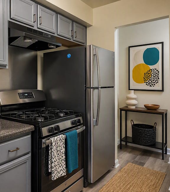 A modern kitchen with a black fridge and stove.