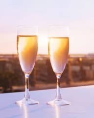 two glasses of champagne outside during sunset