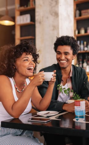 a group of people sitting around a table in a restaurant