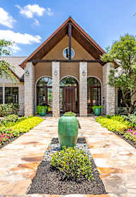 a backyard with a swimming pool and a barbecue grill