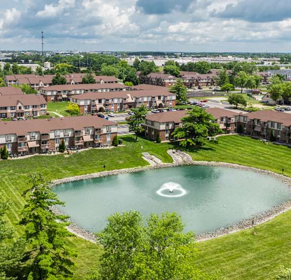 A large pond in the middle of a grassy area surrounded by houses. at Pheasant Run in Lafayette, IN 47909