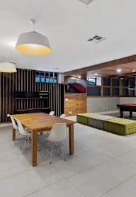 a pool table in a room with large windows