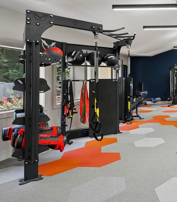 A gym with orange and grey floor tiles.