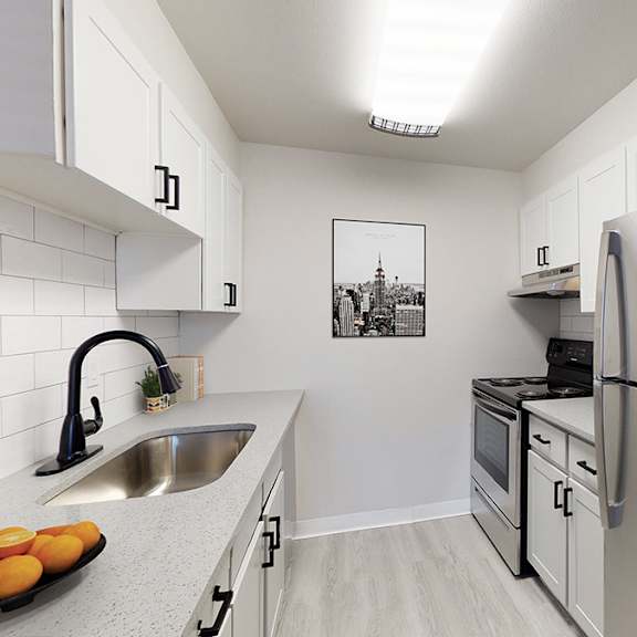 A kitchen with a refrigerator, sink, and oven.