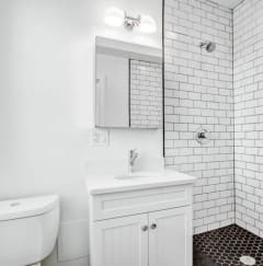 a white bathroom with a sink and a toilet