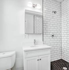 a white bathroom with a sink and a toilet