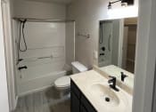 Thumbnail 24 of 27 - a bathroom with a sink toilet and shower at The Lodge Apartments, Tulsa, 74129