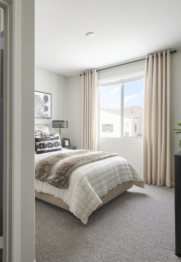 Bedroom with walk in closet at Mitchell Place Apartments in Murrieta, California