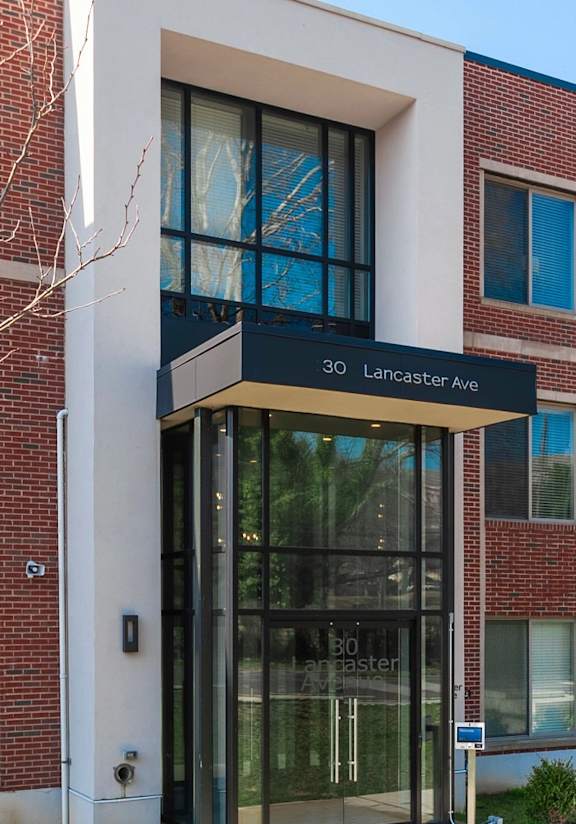 A modern building with a glass entrance and a sign that reads "Lone Star Apartments".