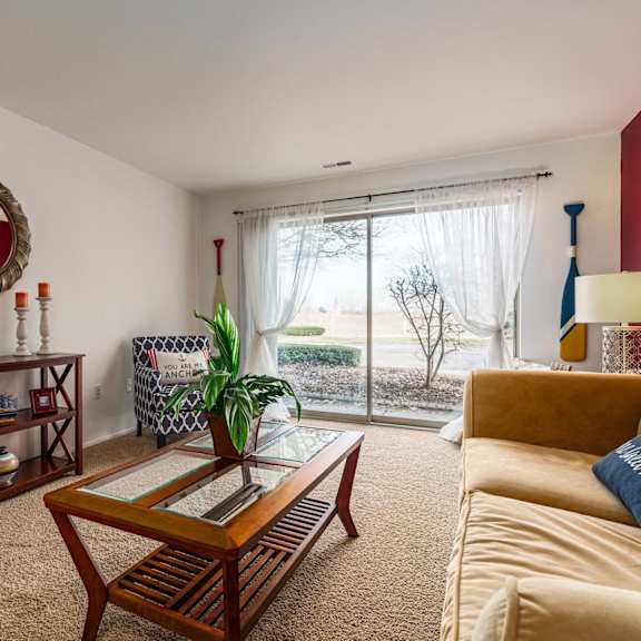 a living room with a couch and a coffee table and a sliding glass door