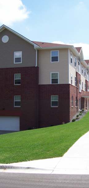 A red truck is parked in front of a building.