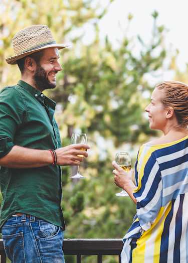 Two people enjoying a glass of wine outside