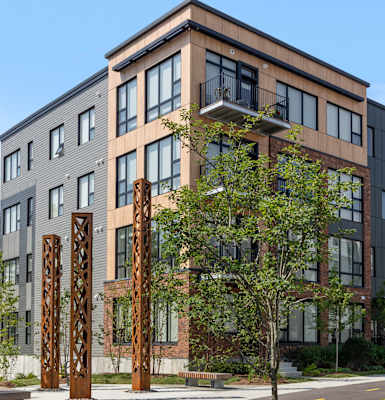 A modern apartment building with a mix of brick and panel facades.