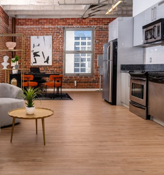 a bedroom with a bed and a brick wall