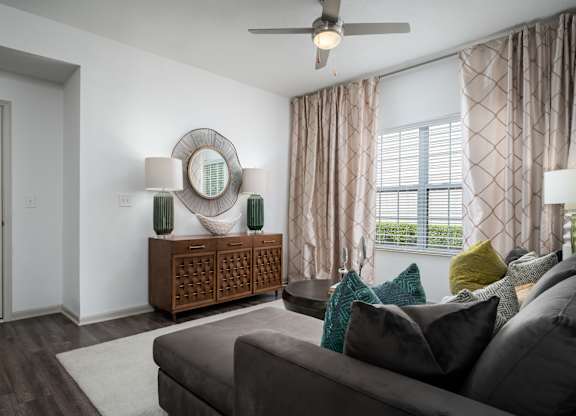 Stylish living space with comfortable seating and natural lighting at The Coleman Apartments