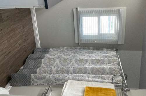 picture of a vanity and shower area covered by a shower curtain