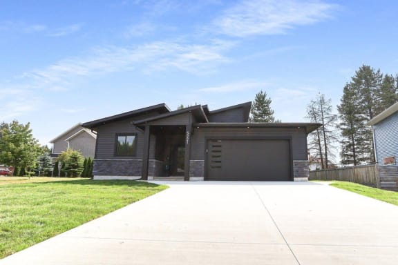 a house with a driveway and a garage door