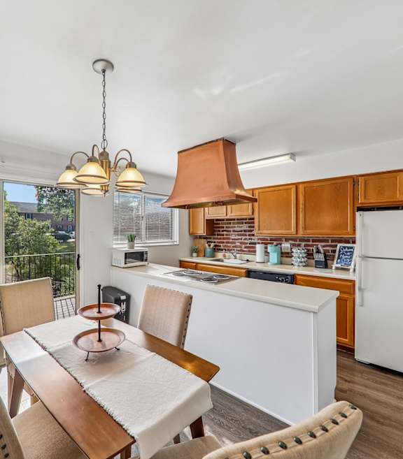 A kitchen with a brick wall and a wooden counter.