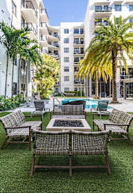 A patio with a table and chairs surrounded by buildings.