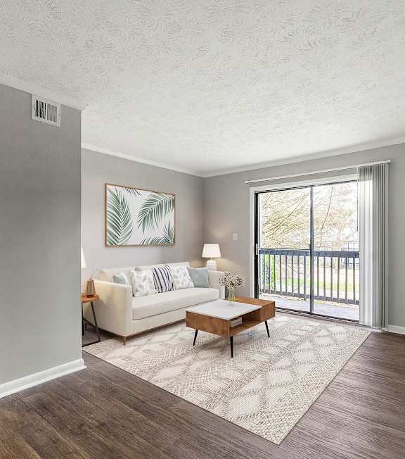 A living room with a white couch and a coffee table.