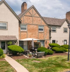 the view of the front of a house with a yard and a sidewalk