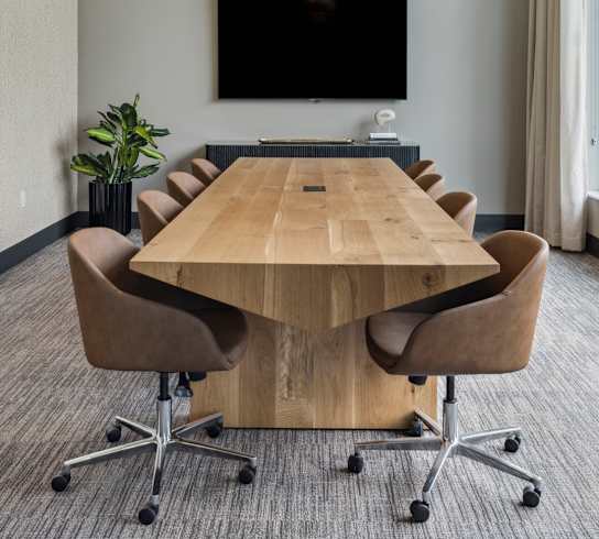 a conference room with a table and chairs and a large window