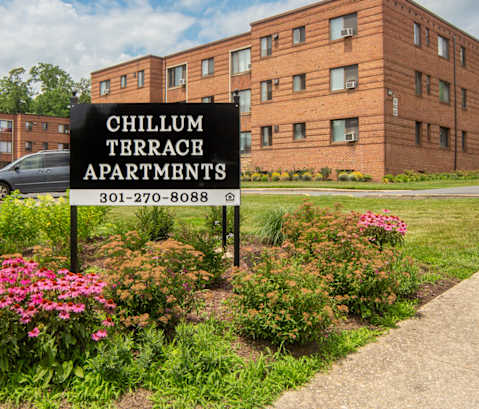 a large brick building with a sign in front of it