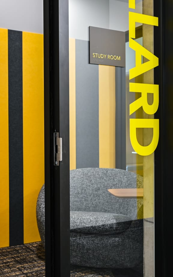a room with two chairs and a sign on the door