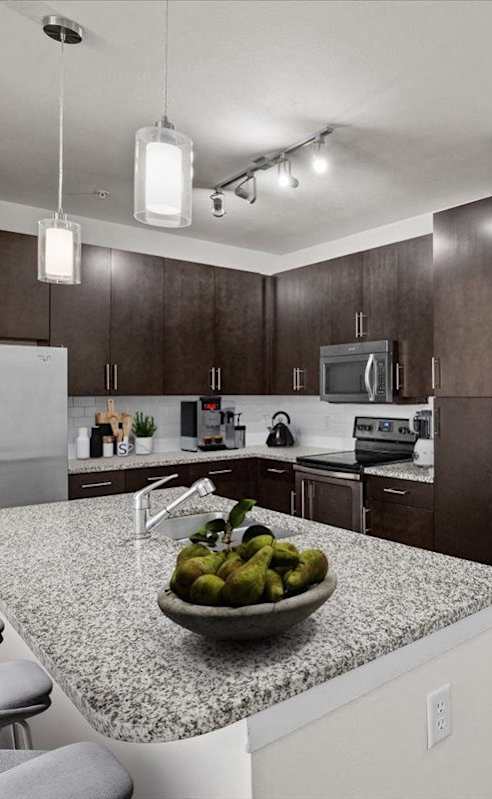 a kitchen with a counter top with a bowl of fruit at West 39th Street Apartments, Kansas City, 64111