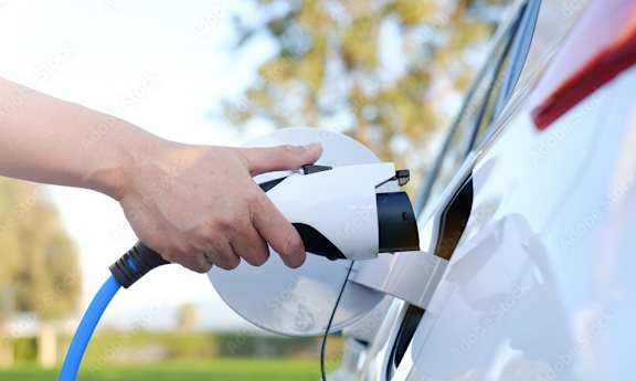 A person is charging an electric car.