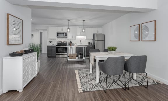 a dining area and kitchen in a 555 waverly unit