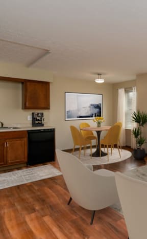 A modern living room with a kitchen area in the background.