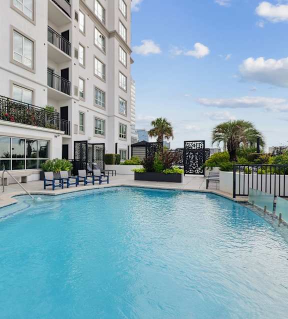 a view of the pool and hot tub at dusk at Dominion Post Oak in Houston, TX